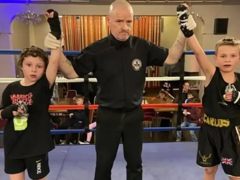 Junior amateur boxer with referee at ABA bout
